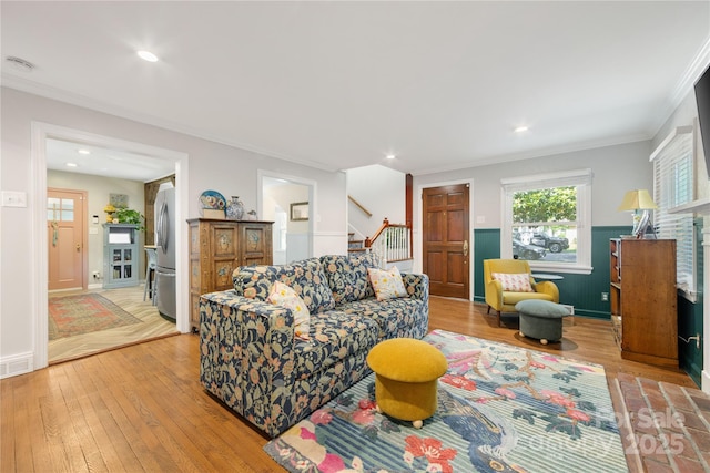 2034 Lanier Ave, Charlotte, NC 28205 - living room featuring ornamental molding, light wood-type flooring, stairs, and recessed lighting