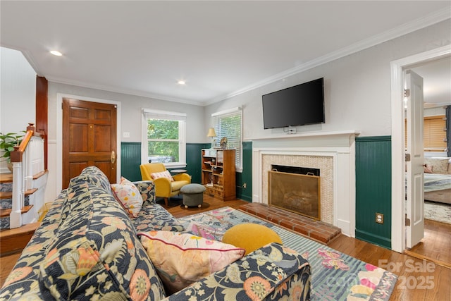 2034 Lanier Ave, Charlotte, NC 28205 - living room with ornamental molding, wood finished floors, a fireplace with raised hearth, and recessed lighting