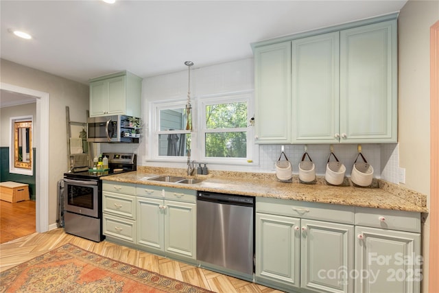 2034 Lanier Ave, Charlotte, NC 28205 - kitchen featuring stainless steel appliances, green cabinetry, decorative backsplash, decorative light fixtures, and light stone counters