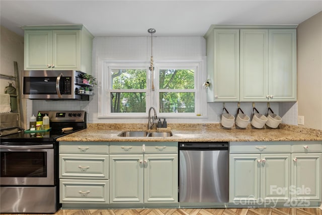 2034 Lanier Ave, Charlotte, NC 28205 - kitchen with green cabinetry, appliances with stainless steel finishes, backsplash, and light stone countertops