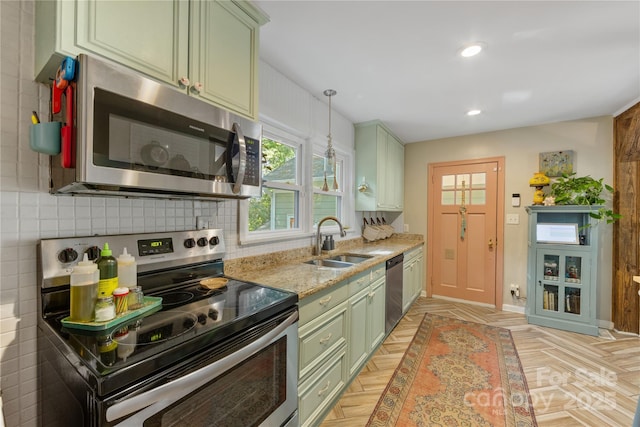 2034 Lanier Ave, Charlotte, NC 28205 - kitchen with stainless steel appliances, decorative backsplash, green cabinetry, light stone countertops, and recessed lighting