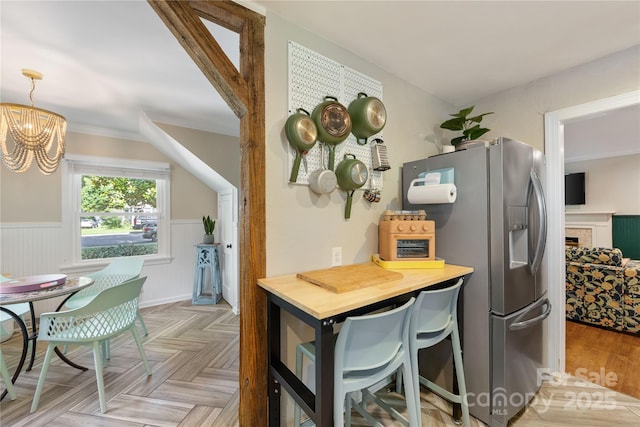 2034 Lanier Ave, Charlotte, NC 28205 - kitchen with stainless steel refrigerator with ice dispenser, a chandelier, and wainscoting