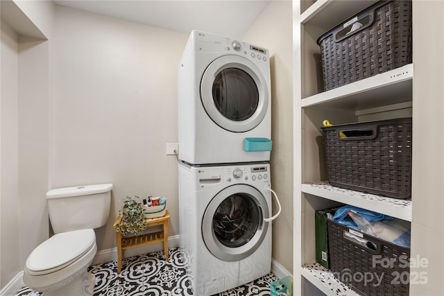2034 Lanier Ave, Charlotte, NC 28205 - washroom with estacked washer and dryer and baseboards