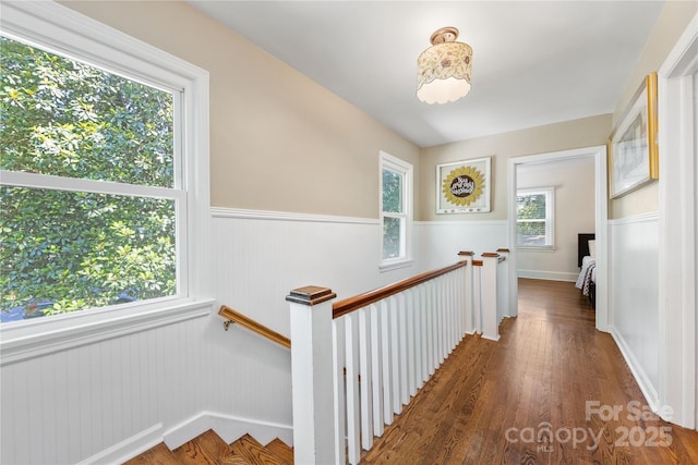 2034 Lanier Ave, Charlotte, NC 28205 - corridor with an upstairs landing, a wainscoted wall, and wood finished floors