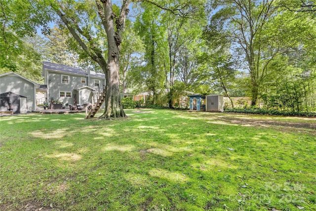 2034 Lanier Ave, Charlotte, NC 28205 - view of green lawn featuring a storage shed and a wooden deck