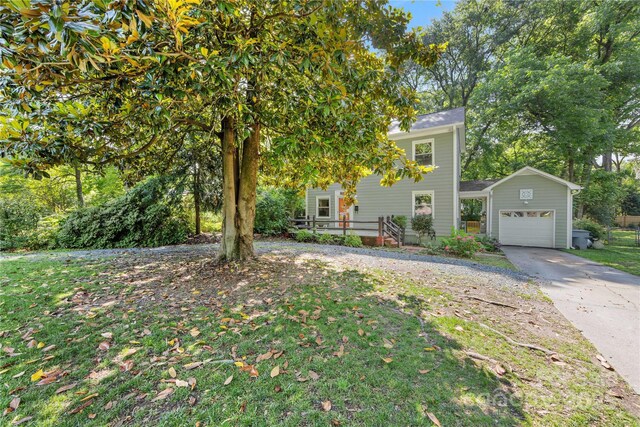 2034 Lanier Ave, Charlotte, NC 28205 - view of property hidden behind natural elements featuring an attached garage, driveway, and a front yard