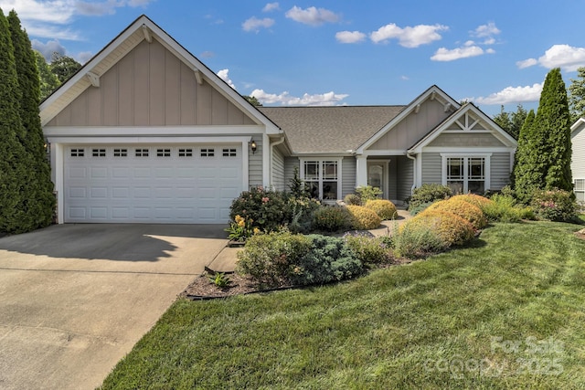 16 Sunview Cir, Arden, NC 28704 - view of front of home with board and batten siding, an attached garage, driveway, a front yard, and roof with shingles