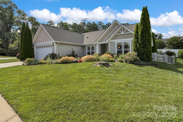 16 Sunview Cir, Arden, NC 28704 - view of front of home featuring board and batten siding, an attached garage, concrete driveway, and a shingled roof