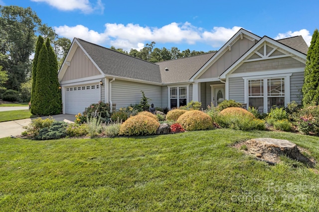 16 Sunview Cir, Arden, NC 28704 - view of front facade with board and batten siding, a garage, a front yard, and a shingled roof