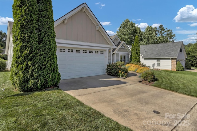 16 Sunview Cir, Arden, NC 28704 - view of front of home with board and batten siding, driveway, a front lawn, and an attached garage