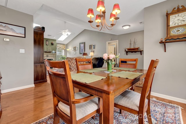 16 Sunview Cir, Arden, NC 28704 - dining space with ceiling fan, light wood finished floors, a chandelier, and vaulted ceiling