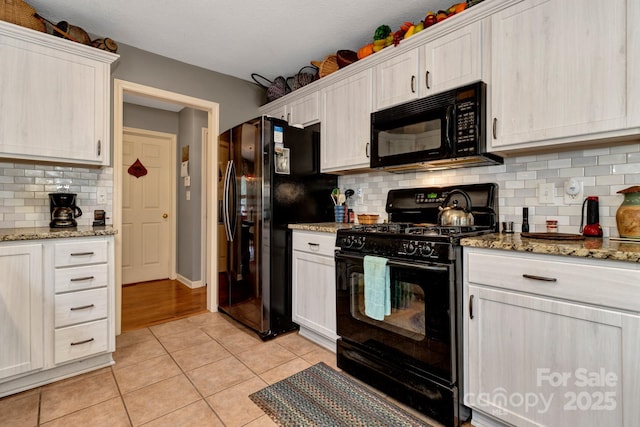 16 Sunview Cir, Arden, NC 28704 - kitchen with black appliances, light tile patterned floors, decorative backsplash, light stone countertops, and white cabinetry