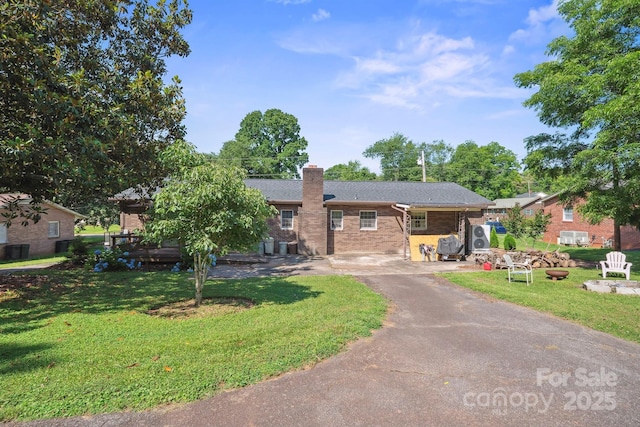 203 Shuping St, Morganton, NC 28655 - ranch-style house featuring asphalt driveway, a front yard, brick siding, and a chimney