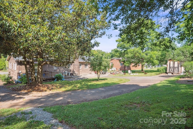 203 Shuping St, Morganton, NC 28655 - view of green lawn with a shed