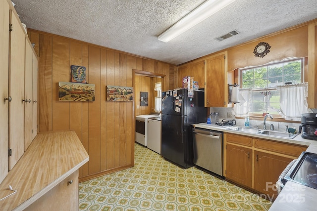 203 Shuping St, Morganton, NC 28655 - kitchen featuring stainless steel dishwasher, freestanding refrigerator, light countertops, brown cabinets, and range