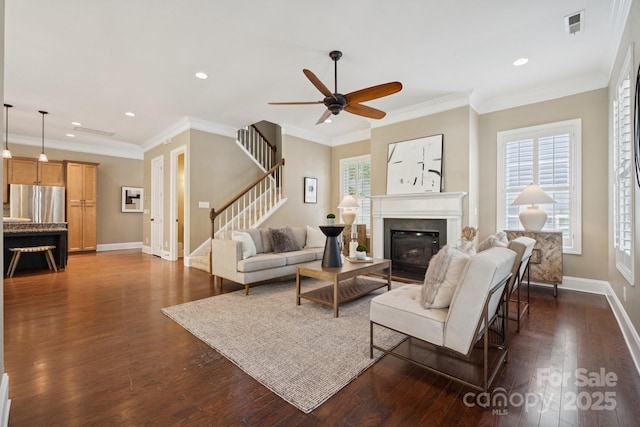 12525 Druids Glen Dr, Pineville, NC 28134 - living room with stairs, dark wood-style floors, recessed lighting, a ceiling fan, and a glass covered fireplace