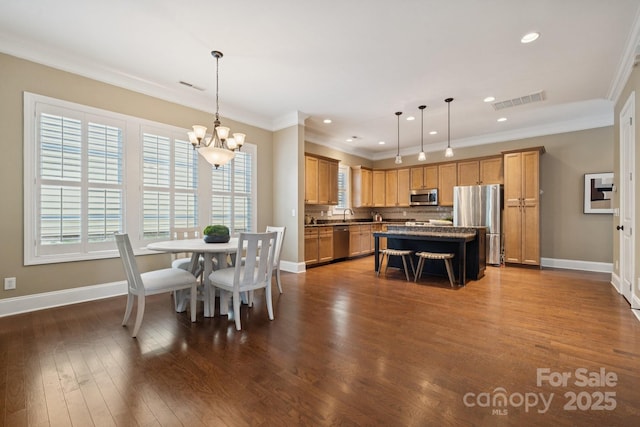 12525 Druids Glen Dr, Pineville, NC 28134 - dining room with a chandelier, ornamental molding, dark wood finished floors, and recessed lighting