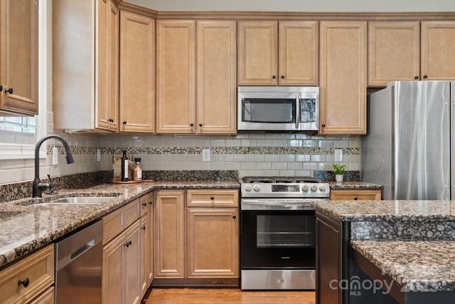 12525 Druids Glen Dr, Pineville, NC 28134 - kitchen with appliances with stainless steel finishes, light wood-style floors, stone counters, and backsplash
