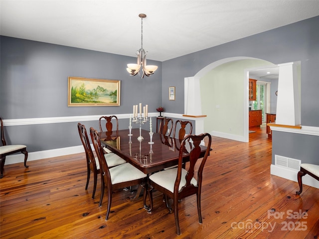 303 S Braeside Ct, Asheville, NC 28803 - dining room with arched walkways, hardwood / wood-style floors, and a chandelier