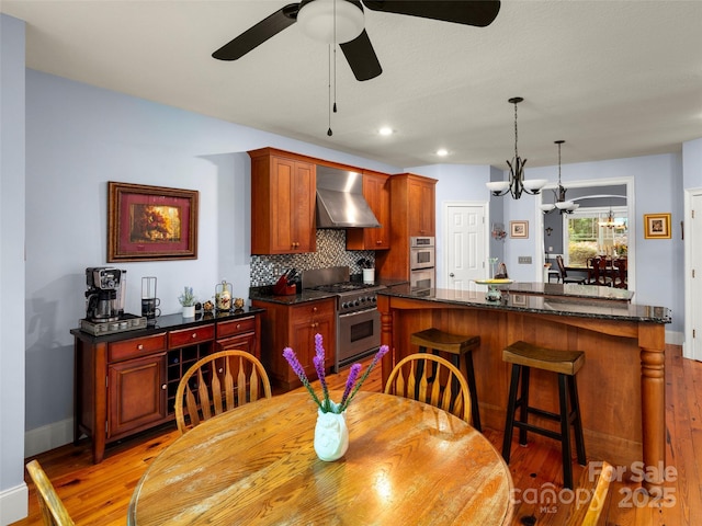 303 S Braeside Ct, Asheville, NC 28803 - dining area with light wood-style floors, ceiling fan, and recessed lighting