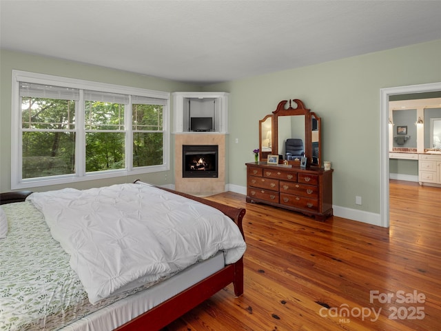 303 S Braeside Ct, Asheville, NC 28803 - bedroom with a lit fireplace and hardwood / wood-style flooring