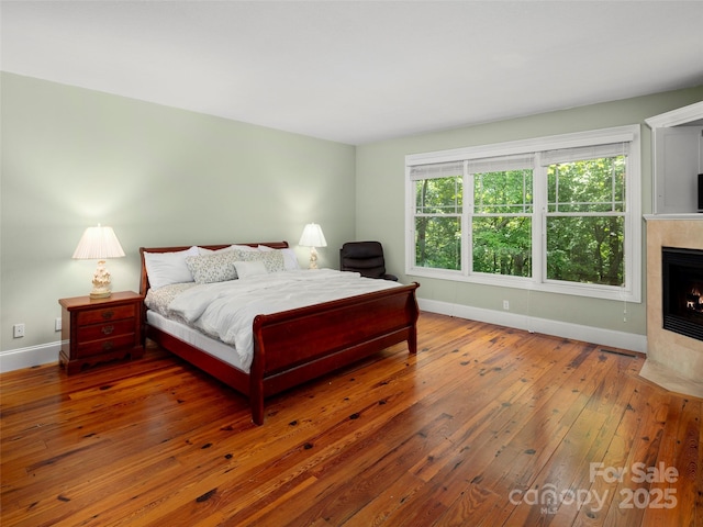 303 S Braeside Ct, Asheville, NC 28803 - bedroom with hardwood / wood-style flooring and a tiled fireplace