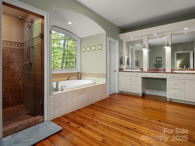303 S Braeside Ct, Asheville, NC 28803 - full bath with vanity, a stall shower, wood-type flooring, a bath, and recessed lighting