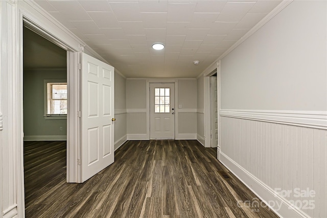 613 E Liberty St, Salisbury, NC 28144 - doorway with dark wood-style flooring, a wainscoted wall, and ornamental molding
