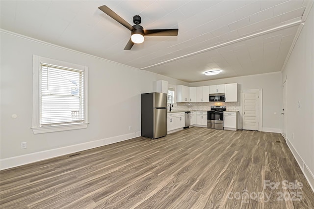 613 E Liberty St, Salisbury, NC 28144 - kitchen featuring stainless steel appliances, crown molding, wood finished floors, white cabinets, and light countertops