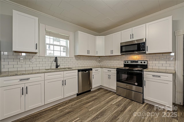 613 E Liberty St, Salisbury, NC 28144 - kitchen featuring appliances with stainless steel finishes, crown molding, dark wood-type flooring, and white cabinets