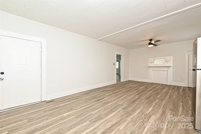 613 E Liberty St, Salisbury, NC 28144 - unfurnished living room featuring ornamental molding, wood finished floors, and ceiling fan