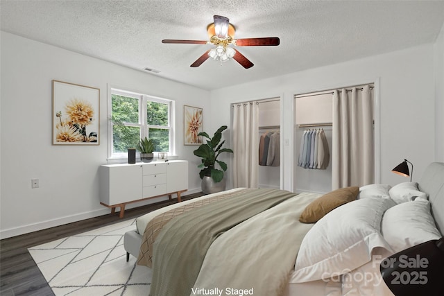 2526 Hankins Rd, Marion, NC 28752 - bedroom with wood finished floors, a textured ceiling, ceiling fan, and multiple closets