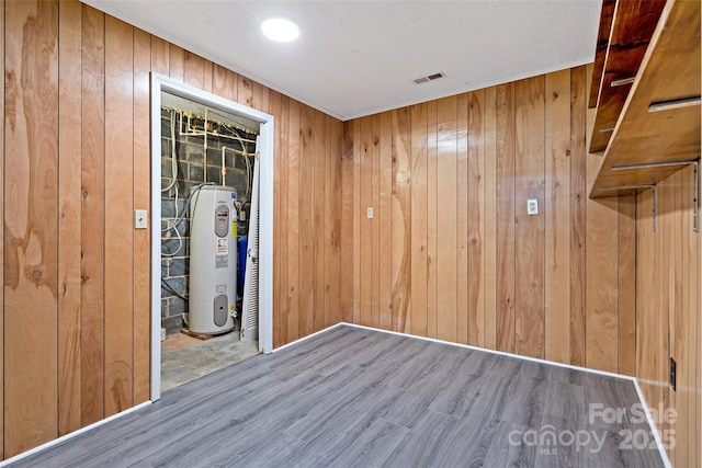 2526 Hankins Rd, Marion, NC 28752 - spare room with water heater, wood finished floors, and wood walls