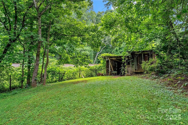 2526 Hankins Rd, Marion, NC 28752 - view of green lawn with an outdoor structure and a wooded view