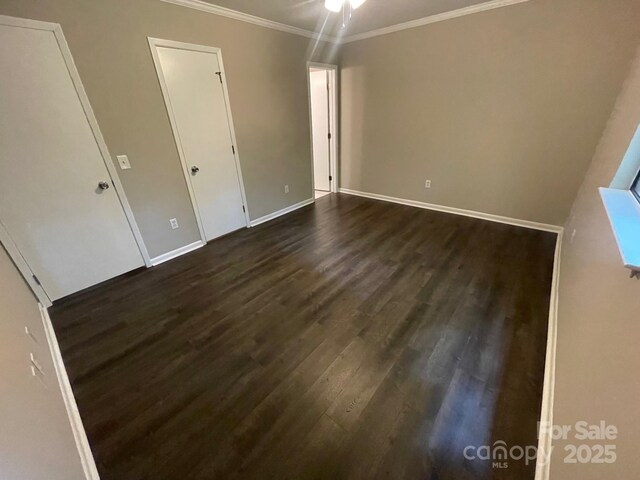 3200 Heathstead Pl Unit E, Charlotte, NC 28210 - unfurnished bedroom featuring dark wood finished floors and ornamental molding