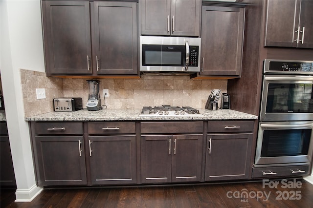 660 Highgarden Ln, Boiling Springs, SC 29316 - kitchen featuring appliances with stainless steel finishes, dark brown cabinets, tasteful backsplash, and dark wood-type flooring