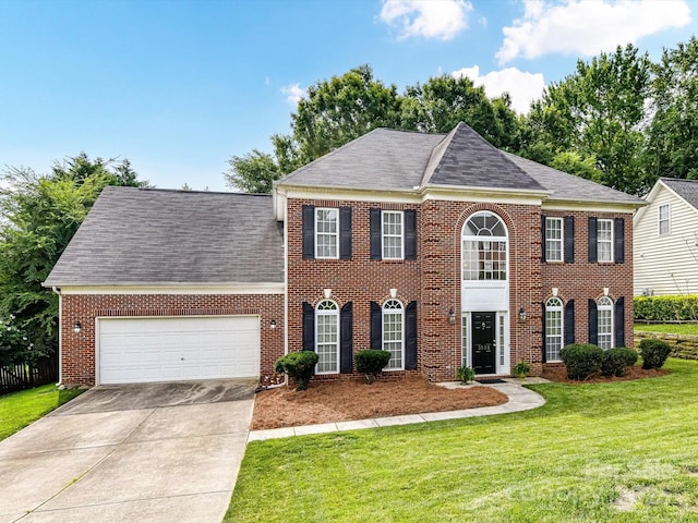 3533 Weddington Ridge Ln, Matthews, NC 28105 - georgian-style home with a garage, concrete driveway, brick siding, a front yard, and roof with shingles