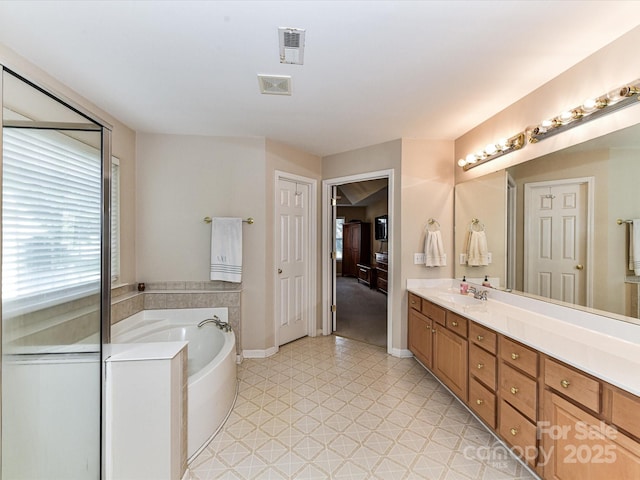 3533 Weddington Ridge Ln, Matthews, NC 28105 - bathroom with a garden tub, double vanity, and tile patterned floors