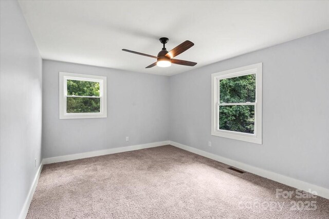 10514 Harbor Dr, Charlotte, NC 28214 - empty room with healthy amount of natural light, carpet flooring, and ceiling fan