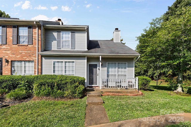 6113 Windsor Gate Ln Unit 6113, Charlotte, NC 28215 - view of front of property with a chimney, a front lawn, and a porch