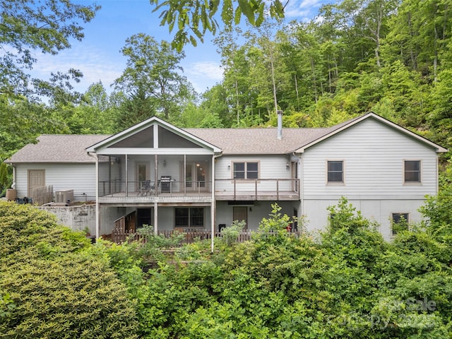 253 Sandy Ln, Brevard, NC 28712 - back of house featuring a sunroom, roof with shingles, and stairway