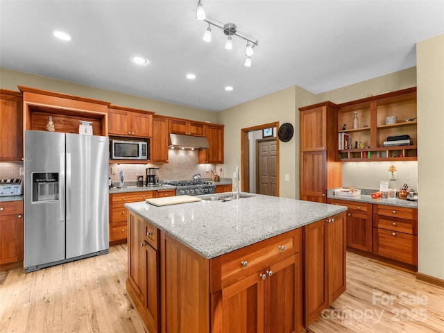 253 Sandy Ln, Brevard, NC 28712 - kitchen featuring appliances with stainless steel finishes, open shelves, under cabinet range hood, light wood-style floors, and brown cabinetry