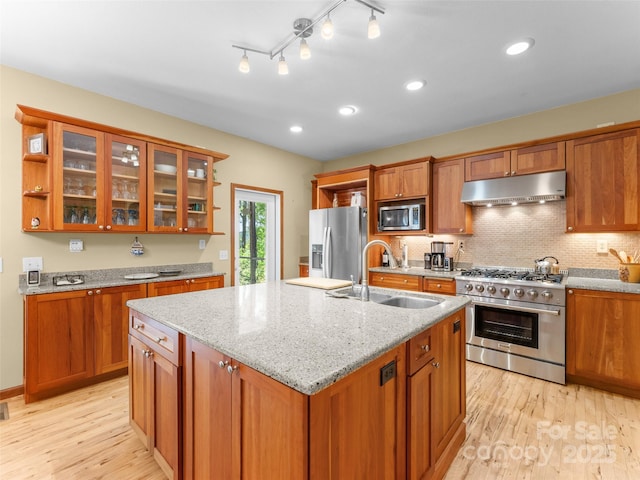 253 Sandy Ln, Brevard, NC 28712 - kitchen featuring appliances with stainless steel finishes, under cabinet range hood, brown cabinetry, light wood-style flooring, and recessed lighting