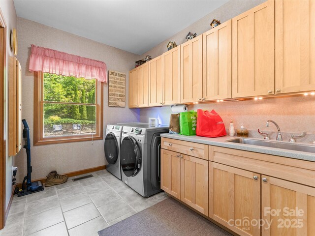 253 Sandy Ln, Brevard, NC 28712 - washroom featuring washer and clothes dryer, cabinet space, and light tile patterned floors