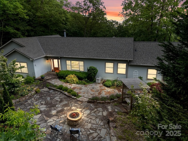 253 Sandy Ln, Brevard, NC 28712 - view of front of home with a fire pit, roof with shingles, and a patio area