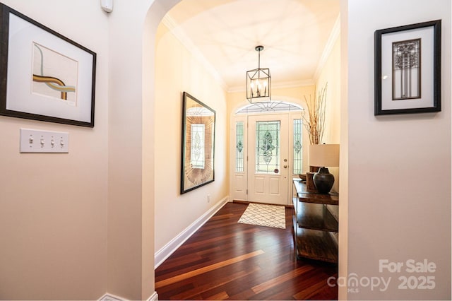 4010 Carlton Dr, Claremont, NC 28610 - entryway featuring ornamental molding, dark wood-type flooring, a chandelier, and arched walkways