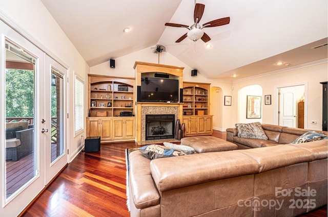 4010 Carlton Dr, Claremont, NC 28610 - living area featuring ceiling fan, lofted ceiling, dark wood-type flooring, a fireplace, and arched walkways