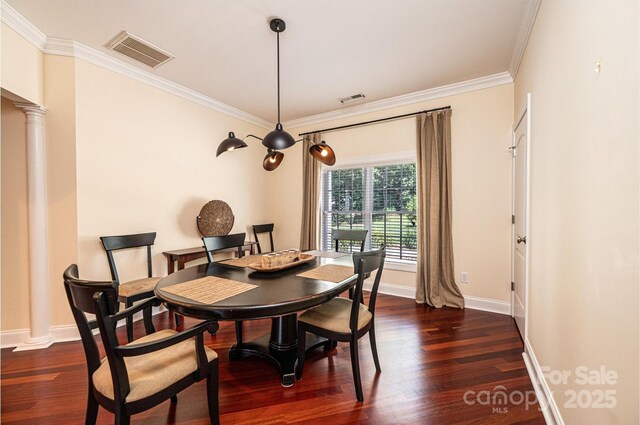 4010 Carlton Dr, Claremont, NC 28610 - dining space featuring crown molding, dark wood-type flooring, and ornate columns