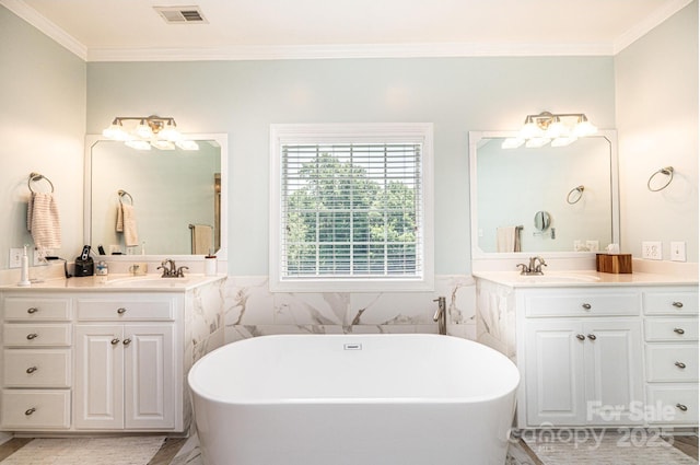 4010 Carlton Dr, Claremont, NC 28610 - bathroom featuring a freestanding bath, ornamental molding, two vanities, and tile walls