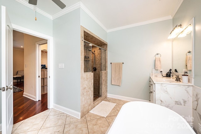 4010 Carlton Dr, Claremont, NC 28610 - bathroom with a stall shower, ornamental molding, a freestanding bath, a ceiling fan, and a walk in closet